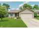 Charming single-story home featuring a two-car garage, well-manicured lawn, and blue shutters at 15388 Dry Creek Rd, Noblesville, IN 46060