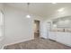 Eat-in kitchen with lots of light, wood-look floors and white appliances and cabinets at 15388 Dry Creek Rd, Noblesville, IN 46060