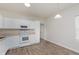 Bright kitchen featuring white cabinetry, modern appliances, and a wood-look floor at 15388 Dry Creek Rd, Noblesville, IN 46060