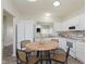 Bright eat-in kitchen features white cabinetry, neutral counters and flooring, and modern appliances at 15388 Dry Creek Rd, Noblesville, IN 46060