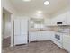 Spacious kitchen featuring white appliances and cabinets with durable wood-look flooring at 15388 Dry Creek Rd, Noblesville, IN 46060