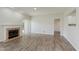 Bright living room with fireplace, hardwood floors, and an open doorway at 15388 Dry Creek Rd, Noblesville, IN 46060