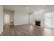 Well-lit living room with hardwood floors, a fireplace, and bathroom doorway at 15388 Dry Creek Rd, Noblesville, IN 46060