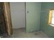 Partially finished bathroom featuring new drywall, a window, and exposed brick at 1601 Spann Ave, Indianapolis, IN 46203
