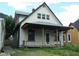 Exterior of a two-story home with a covered porch needing renovation at 1601 Spann Ave, Indianapolis, IN 46203