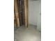 An unfinished room with exposed brick, wooden beams, and framing, offering a rustic yet customizable design at 1601 Spann Ave, Indianapolis, IN 46203