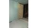 A room with one wall with wooden paneling and another with green drywall at 1601 Spann Ave, Indianapolis, IN 46203