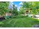 Beautiful backyard featuring lush green grass, well-maintained trees, and manicured landscaping at 16057 Coleman Dr, Westfield, IN 46074
