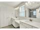 A bathroom featuring double sinks with white countertops, cabinets, and brushed nickel fixtures at 16057 Coleman Dr, Westfield, IN 46074