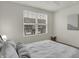Inviting bedroom with neutral tones, ceiling fan, large window, and a comfortable bed with soft pillows at 16057 Coleman Dr, Westfield, IN 46074