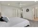 A bedroom with gray carpet features a bed with gray and white striped bedding and a ceiling fan at 16057 Coleman Dr, Westfield, IN 46074