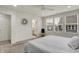 A bright bedroom with carpeted floors, a ceiling fan, three windows, and access to an ensuite bathroom at 16057 Coleman Dr, Westfield, IN 46074