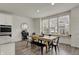Open-concept dining area with a wooden table, black chairs, and view of the kitchen at 16057 Coleman Dr, Westfield, IN 46074