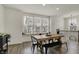 Bright dining area with a wooden table, black chairs, and large windows at 16057 Coleman Dr, Westfield, IN 46074