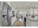 Bright modern kitchen with white cabinets, stainless steel appliances, and an island with a beautiful quartz countertop at 16057 Coleman Dr, Westfield, IN 46074