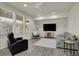 Bright living room featuring hardwood floors, white walls, and large windows overlooking the neighborhood at 16057 Coleman Dr, Westfield, IN 46074