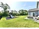 Spacious backyard with lush green grass, a playset, and a patio area perfect for outdoor entertaining at 17390 Tribute Row, Noblesville, IN 46060
