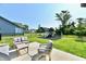 Backyard with patio set and playground featuring a slide and swing set, ideal for relaxation and play at 17390 Tribute Row, Noblesville, IN 46060