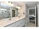 Bathroom featuring a double vanity, quartz countertop, and a walk-in shower at 17390 Tribute Row, Noblesville, IN 46060