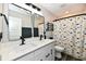 Bathroom with double sink vanity, quartz countertops, and a dinosaur print shower curtain at 17390 Tribute Row, Noblesville, IN 46060