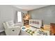 Adorable Bedroom featuring a crib, bookcase, and cozy armchair creating a peaceful environment at 17390 Tribute Row, Noblesville, IN 46060