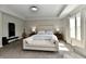 Bright bedroom featuring a tray ceiling, neutral decor, and a large window for plenty of natural light at 17390 Tribute Row, Noblesville, IN 46060