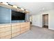 Modern bedroom with built-in shelving, entertainment center, and walk in closet at 17390 Tribute Row, Noblesville, IN 46060
