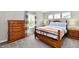 Inviting bedroom featuring matching nightstands, a dresser, and large windows for natural light at 17390 Tribute Row, Noblesville, IN 46060