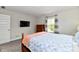 Cozy bedroom with television, natural light, and neutral colors, offering a relaxing retreat at 17390 Tribute Row, Noblesville, IN 46060