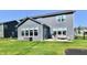Rear exterior featuring a patio and grill, with ample seating and a lush lawn at 17390 Tribute Row, Noblesville, IN 46060