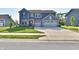 Charming two-story home with a manicured lawn, a two-car garage, and inviting curb appeal at 17390 Tribute Row, Noblesville, IN 46060