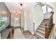 Welcoming foyer with a staircase, neutral tones, stylish lighting, and decorative accents at 17390 Tribute Row, Noblesville, IN 46060