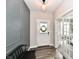Charming foyer features detailed accent wall, a wreath on the front door, and glass french doors at 17390 Tribute Row, Noblesville, IN 46060