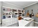 This home office has custom built-ins, neutral paint and decor, and built-in lighting at 17390 Tribute Row, Noblesville, IN 46060