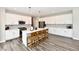 The bright kitchen boasts a large island with a breakfast bar, stainless appliances, and modern cabinetry at 17390 Tribute Row, Noblesville, IN 46060