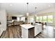 Open concept living includes kitchen with large island, and dining area, and living room with fireplace at 17390 Tribute Row, Noblesville, IN 46060
