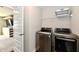 Functional laundry room with modern front-load washer and dryer, plus overhead storage shelf at 17390 Tribute Row, Noblesville, IN 46060