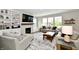 Bright living room featuring a fireplace, built-in shelving, and large windows for natural light at 17390 Tribute Row, Noblesville, IN 46060