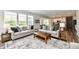Spacious living area with stylish furniture, a decorative rug, and plenty of natural light at 17390 Tribute Row, Noblesville, IN 46060