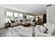 Spacious living room features large windows, neutral decor, and an open layout at 17390 Tribute Row, Noblesville, IN 46060