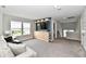 Bright living room with a modern entertainment center and comfortable seating at 17390 Tribute Row, Noblesville, IN 46060