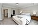 Spacious main bedroom with a king-size bed, neutral decor, and ample natural light at 17390 Tribute Row, Noblesville, IN 46060