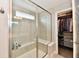 Modern bathroom shower featuring a glass door, built-in bench, and tiled walls at 17390 Tribute Row, Noblesville, IN 46060