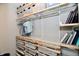 Walk-in closet featuring custom shelving with drawers and hanging space for optimal storage and organization at 17390 Tribute Row, Noblesville, IN 46060