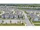 Aerial view of the neighborhood showcasing a serene lake, lush greenery, and charming homes at 1892 Ponsonby Dr, Westfield, IN 46074
