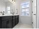 Elegant bathroom featuring a double sink vanity, modern fixtures, and a large window for natural light at 1892 Ponsonby Dr, Westfield, IN 46074
