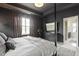 Serene bedroom featuring a four-poster bed, dresser, large window, and contemporary decor at 1892 Ponsonby Dr, Westfield, IN 46074