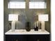 Stylish buffet featuring elegant lamps, modern vases, and a marble countertop, complemented by patterned wallpaper at 1892 Ponsonby Dr, Westfield, IN 46074