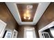 Decorative ceiling with recessed panel, unique light fixture, and textured wallpaper at 1892 Ponsonby Dr, Westfield, IN 46074