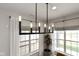 Dining room with bright windows, sheer curtains, a modern chandelier, and a green potted plant at 1892 Ponsonby Dr, Westfield, IN 46074